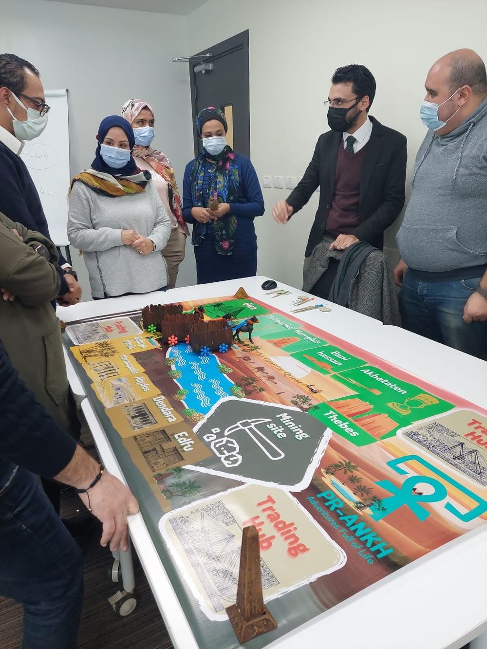 Teams gathered around the Granite Quest board