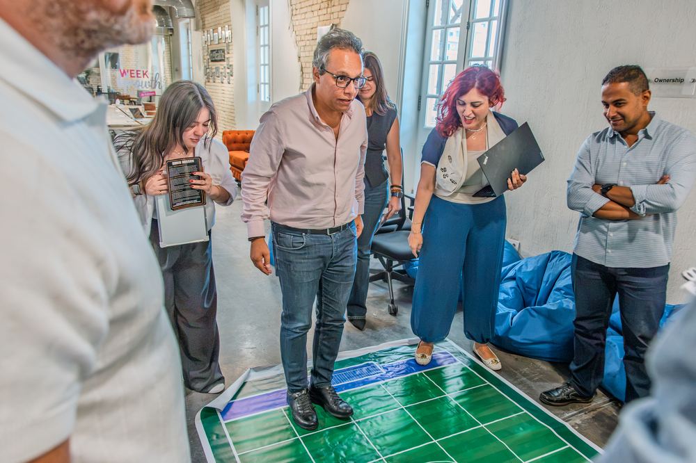 Team huddled around the Momentum Football board