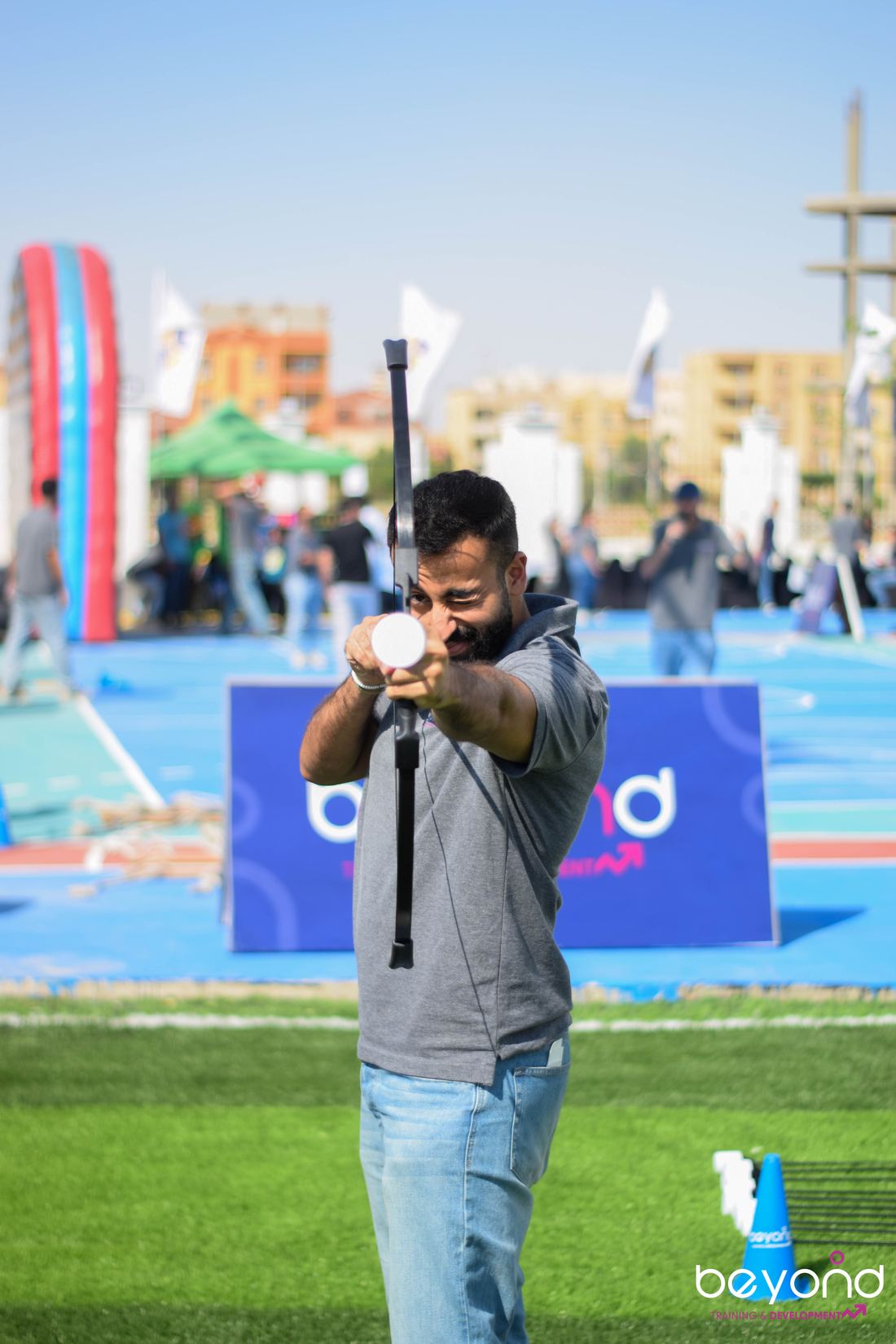 A participant taking aim during an archery activity