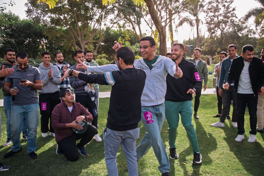 Participants dancing and playing percussion together