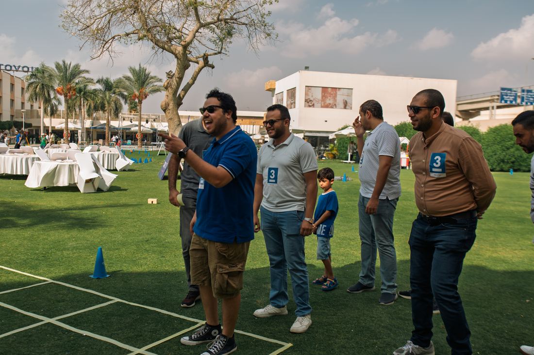 A team working through a grid-based puzzle challenge outdoors